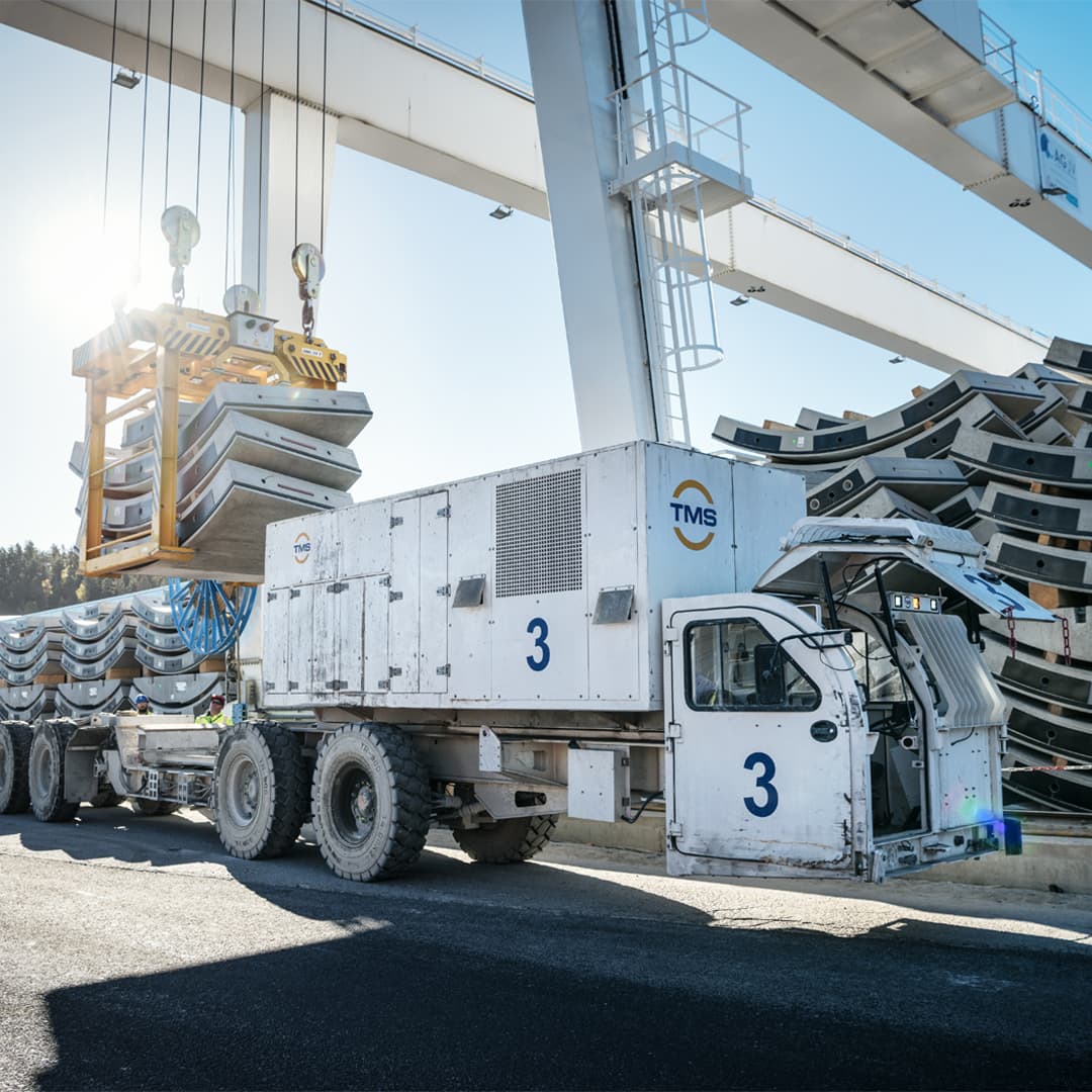 Multi-service vehicle onto which segments are loaded with a crane.